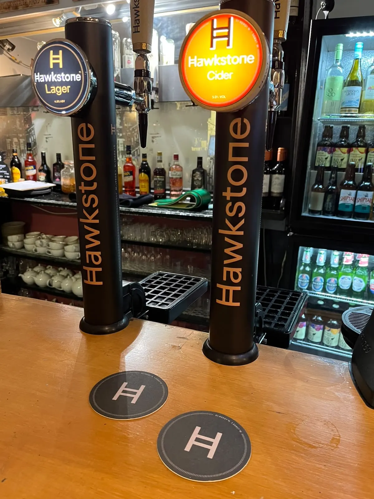 Hawkstone Lager and Hawkstone Cider taps on the bar at The Malcolm Arms