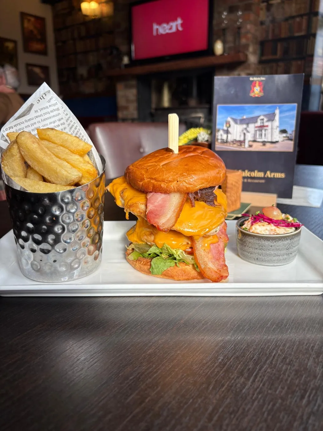 Cheese and bacon burger with chunky chips and slaw