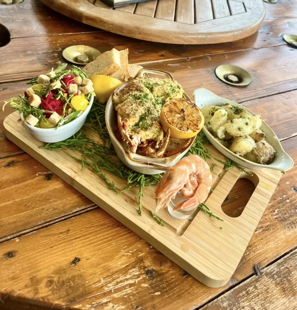 Lobster thermidor board with salad, crusty bread, grilled lemon and a king prawn at The Malcolm Arms