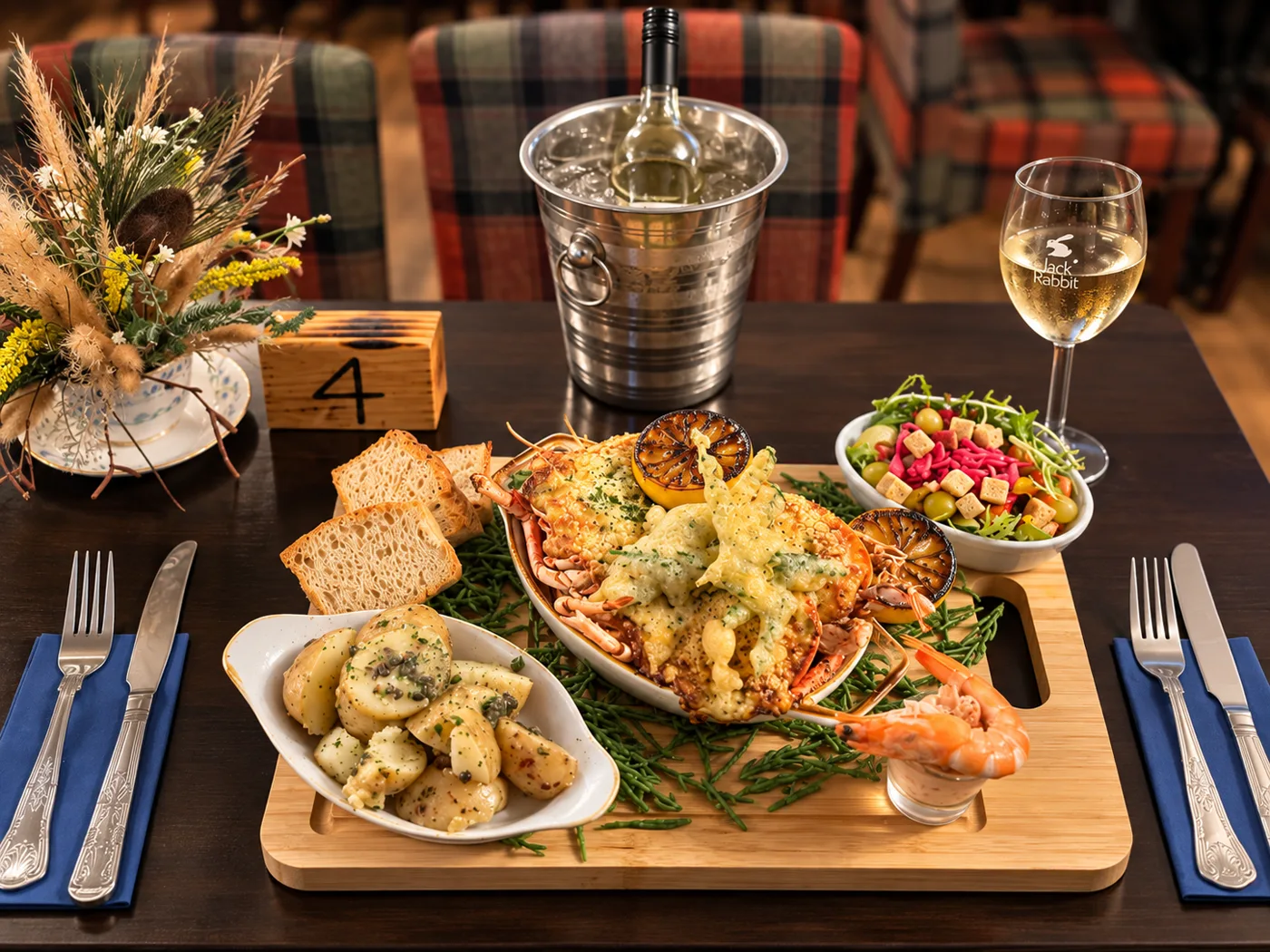 Lobster thermidor served at the table with a glass of white wine at The Malcolm Arms