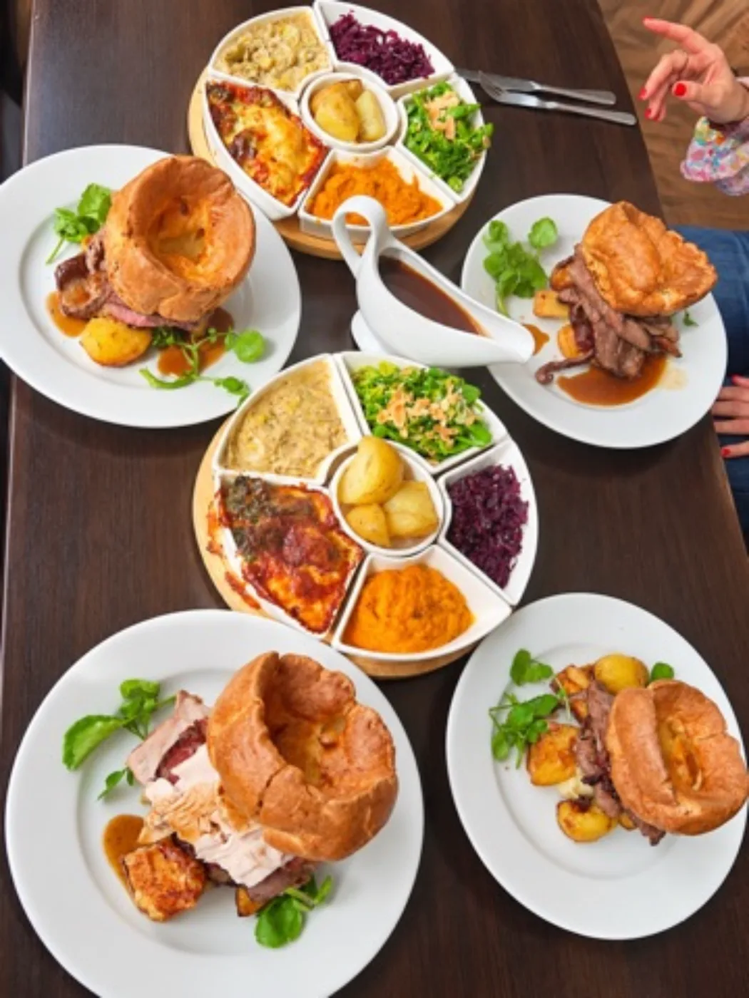 Sunday roast dinners with Yorkshire puddings and sharing vegetables
